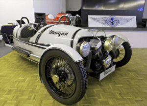 Classic Morgan 3-Wheeler displayed indoors