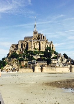 Mont Saint-Michel rises above the sandy tidal flats