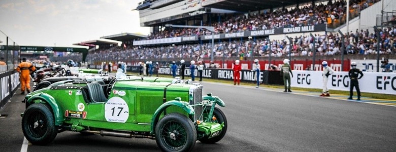 A bright green vintage race car numbered 17
